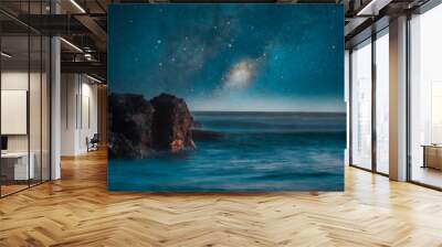 milky way over the sea and rocks on the shore background Wall mural