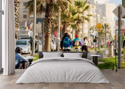 unknown people commuting by bike in the street of La Serena Wall mural