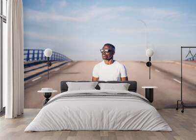 Handsome african man in white shirt posing at camera Wall mural