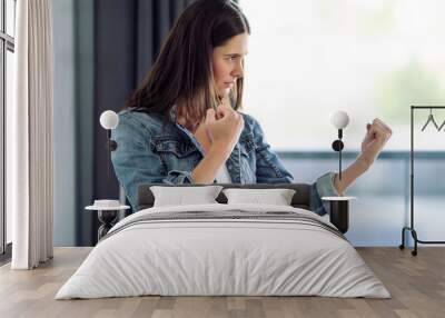 Woman at home in fighting position showing fists Wall mural