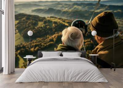 Senior couple taking a scenic helicopter tour over nature Wall mural