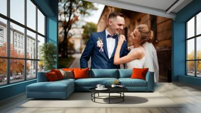 Bride and Groom on Wedding Day in city. Wedding couple after wedding ceremony. Wall mural