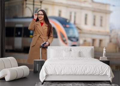 Young beautiful business woman suitcase in urban setting Wall mural