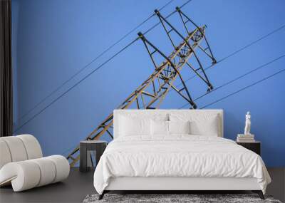 High voltage power grid pylon against blue sky Wall mural