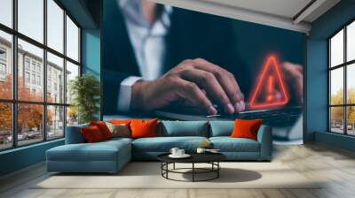 A Businessman developer using laptop computer with triangle caution warning sign for notification error and maintenance concept, network security, computer virus detected, personal data protection. Wall mural