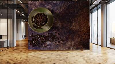 Top view above of Black coffee seed for morning menu in brown ceramic cup with coffee beans roasted on old rusty table background. Flat lay with copy space. Wall mural