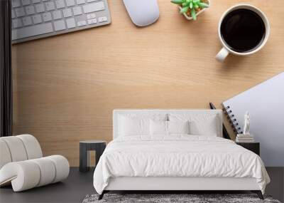 Top view above of Wooden office desk table with keyboard, notebook and coffee cup with equipment other office supplies. Business and finance concept. Workplace, Flat lay with blank copy space. Wall mural