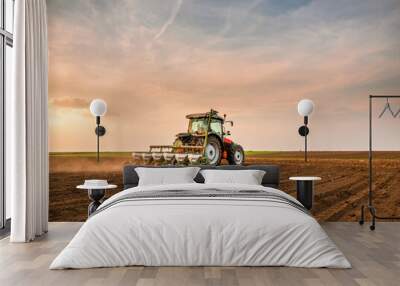 Tractor drilling seeding crops at farm field. Agricultural activity. Wall mural