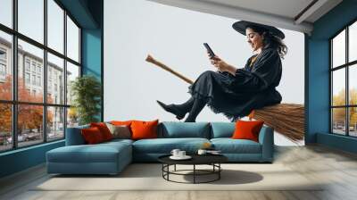 a witch looking at her smartphone Wall mural