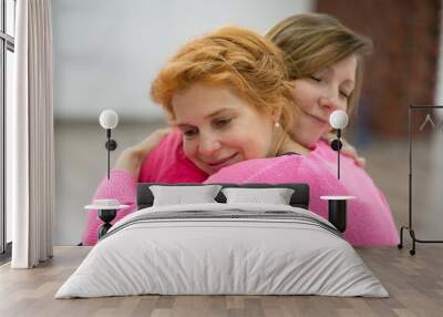 Two women are hugging Wall mural