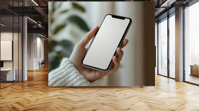 Hand Holding a Smartphone with a Blank Screen Wall mural