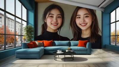 Two smiling Asian women wearing black turtlenecks Wall mural