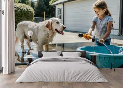 A girl is playing giving water to a large dog from a hose using a toy truck as a water bowl.
 Wall mural