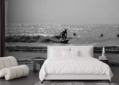 A man is surfing on a surfboard in Agadir beach in black and white Wall mural