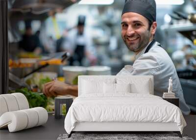 A smiling chef is preparing food in a kitchen Wall mural