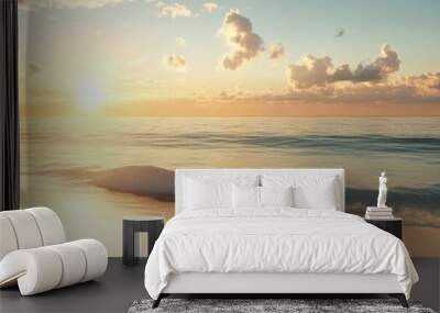 A beautiful beach with golden sand and calm seawater at sunset. Wall mural