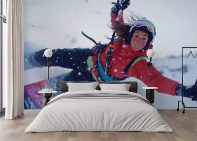 A skier performs a dynamic maneuver in fresh snow, showcasing skill and excitement against a winter backdrop. Wall mural