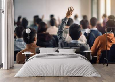 Back view of male raising his hand to answer question or present during training workshop. Wall mural