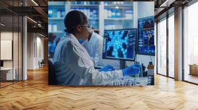 Female biochemist working with computer showing gene therapy interface at medical science laboratory with team of professional biotechnology scientists for developing drugs. Wall mural