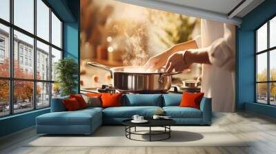 Female using steel metallic pot for preparing in the kitchen. Kitchenware for cooking. Wall mural