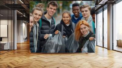 Group of young teenage volunteers with garbage bags after cleaning the streets. Wall mural