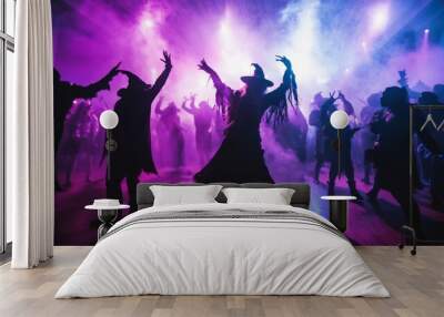 Halloween party dance floor, with guests dressed as witches, vampires, and other spooky characters, dancing under strobe lights. Wall mural