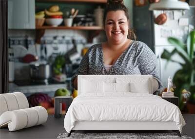 Happy plus size woman standing with fruits for making healthy food in kitchen. Wall mural