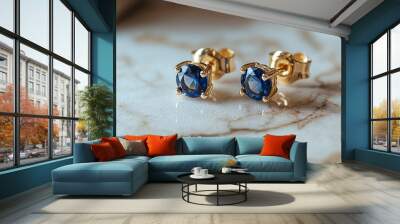 Close-up of a Pair of Golden Earrings with Blue Sapphire Stones Wall mural