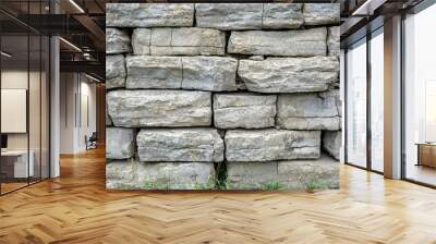 Close-up of a weathered stone wall with visible cracks Wall mural