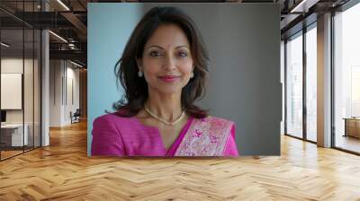 Portrait of a smiling woman wearing a pink saree and jewelry Wall mural