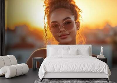 Portrait of a Smiling Woman with Curly Hair Wearing Sunglasses at Sunset Wall mural