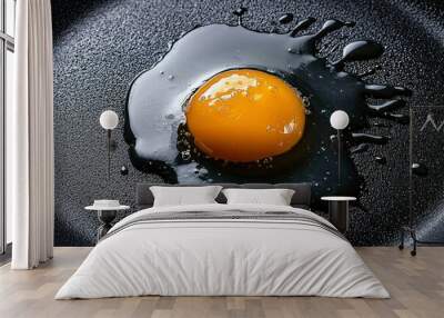 Raw Egg Yolk in a Black Pan with Spilled Egg White Wall mural