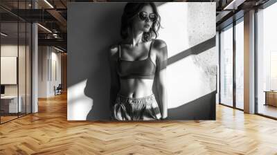 Woman with Sunglasses and Crop Top Posing Against a Wall Wall mural