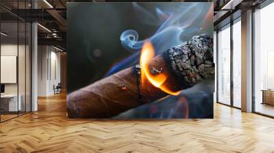 The cigar is ignited with a lighter and has burning fire and ash on top Wall mural