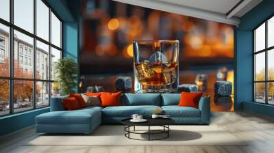 Glass of whiskey with whiskey stones on bar counter on blurred background Wall mural