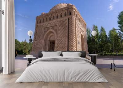 A large building with a dome on top. The building is brown and has a lot of detail. The sky is blue and there are trees in the background Wall mural