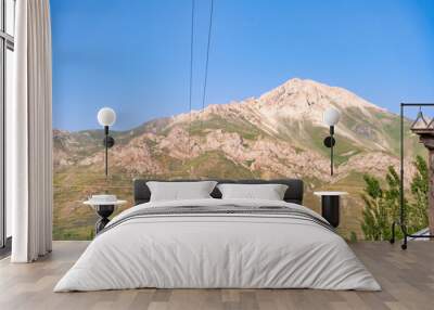 A mountain range with a clear blue sky in the background Wall mural