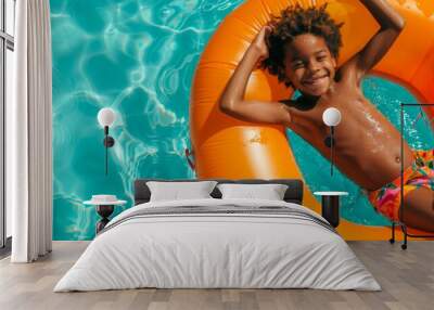 Smiling Black Boy on Orange Float in Pool Wall mural