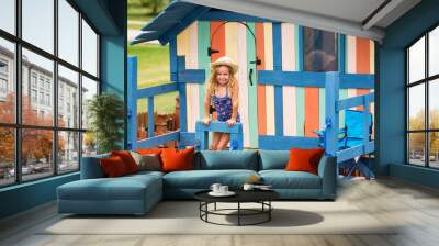 Happy little girl on outdoor playset Wall mural