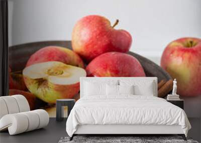 Whole and sliced fresh apples with cinnamon sticks on marble background. Wall mural