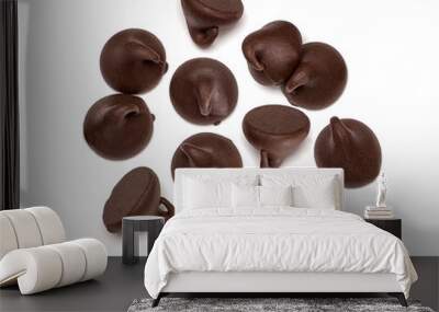 Scattered chocolate chips morsels or drops from top view isolated on white background Wall mural