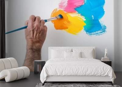 A man is painting a picture with a brush Wall mural