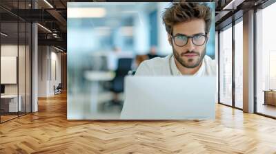 A man is sitting in front of three computer monitors Wall mural