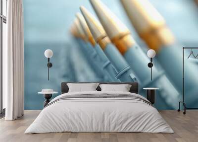 A row of metal tubes with a light bulb in the middle Wall mural