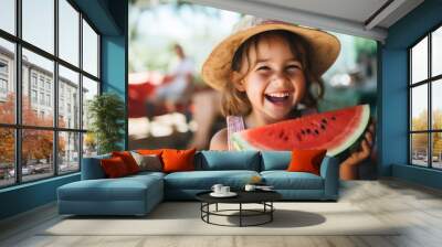 A joyful little girl eats watermelon in nature and smiles. Summer. Wall mural