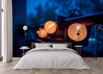 A lighted garland with solar lamps hung on the balustrade of the balcony. Mood light. Evening Wall mural