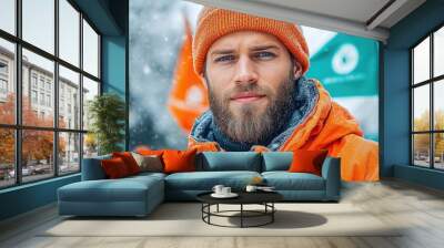 Portrait of bearded man in orange jacket with snowfall background Wall mural