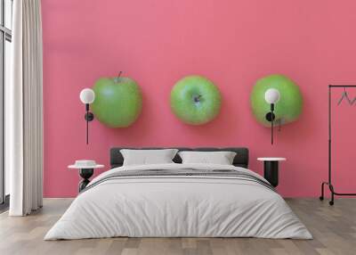 Green natural apples on pink background Wall mural