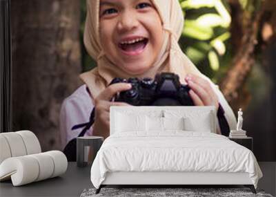 Little school Muslim kid with camera.Happy smile muslim girl with digital devices.Smart kid Wall mural