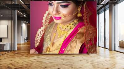 Indian bride dressed in Hindu red traditional wedding clothes sari embroidered with gold jewelry Wall mural